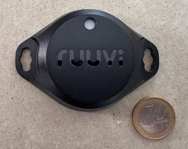 Ruuvi sensor with a 1 euro coin for size comparison